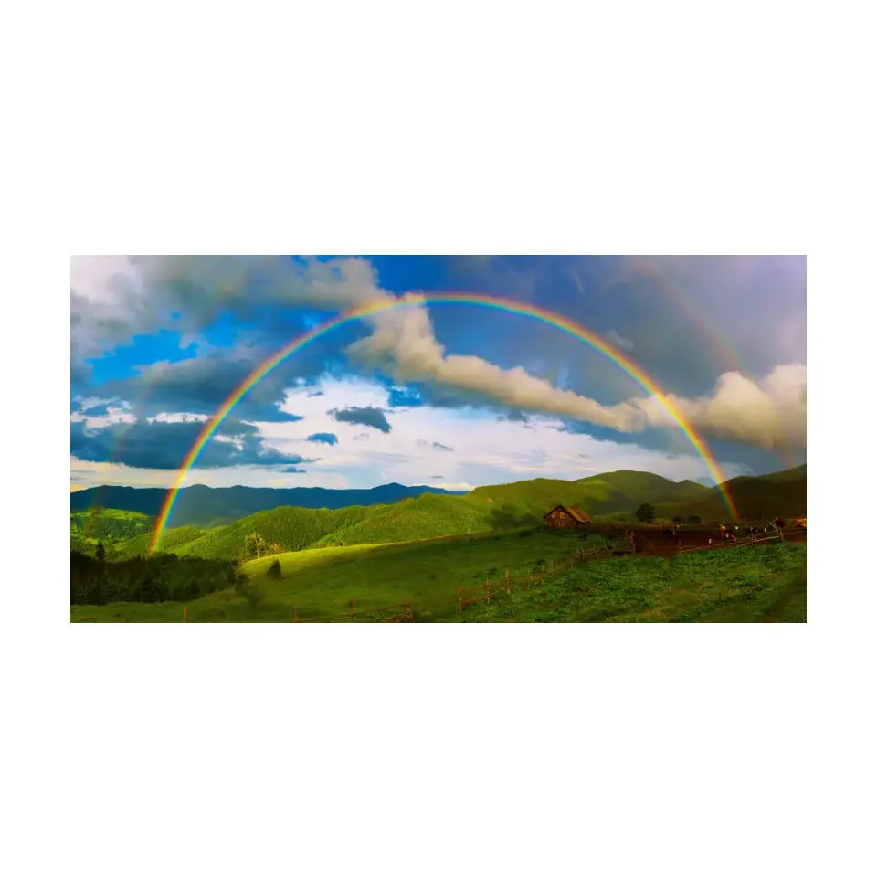 Beautiful mountain valley with green hills and huge rainbow