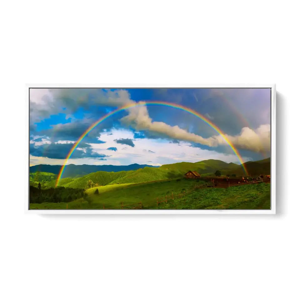 Beautiful mountain valley with green hills and huge rainbow