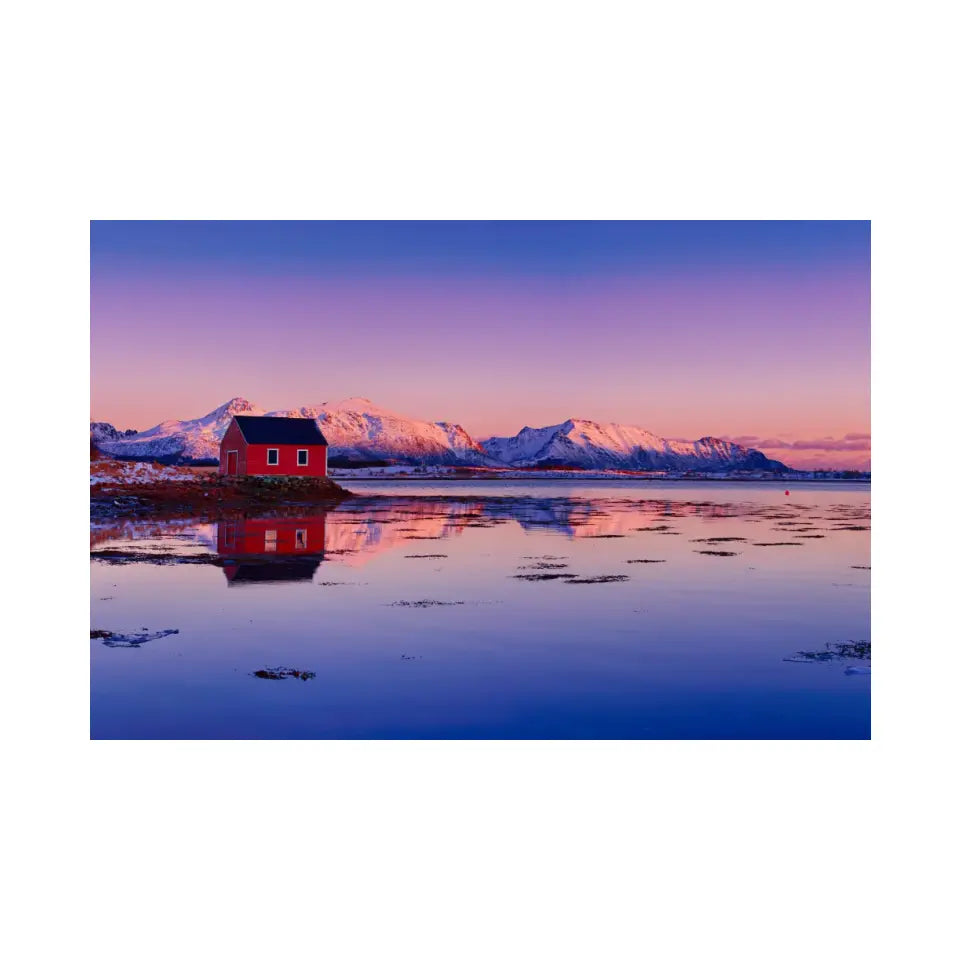 Winter lake, red rorbu house and snowy mountains