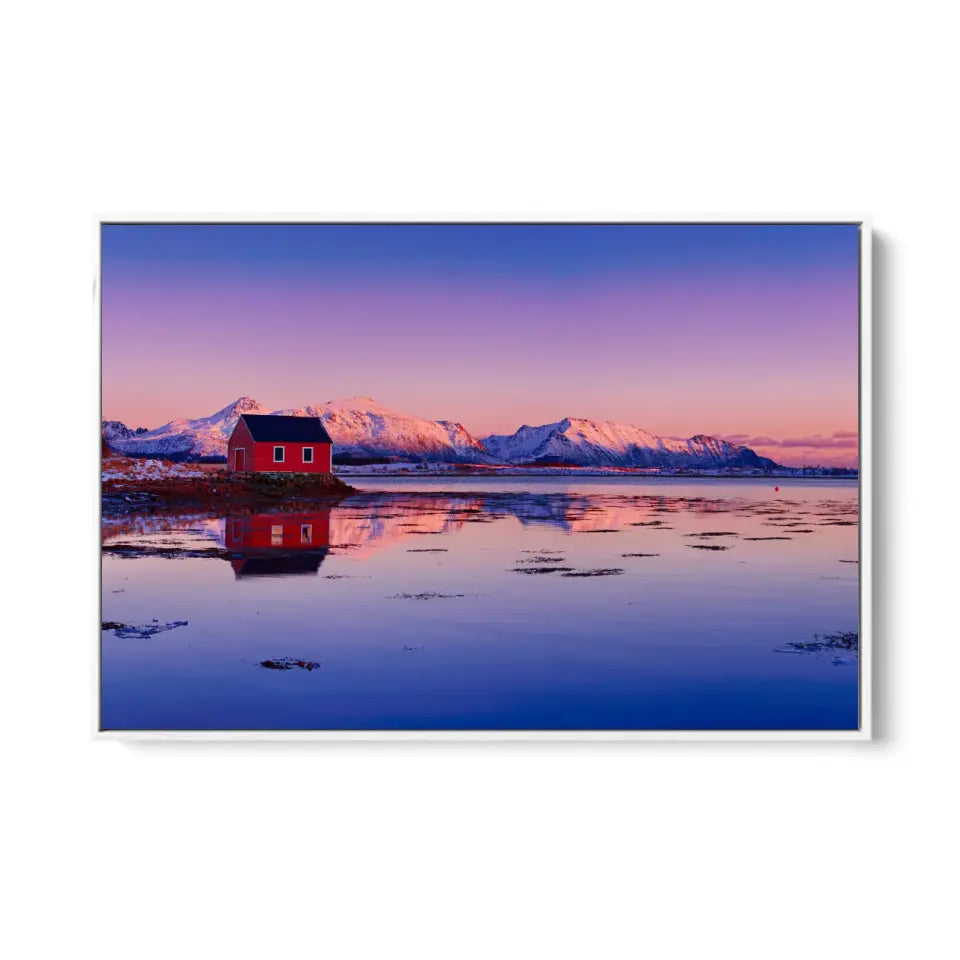 Winter lake, red rorbu house and snowy mountains