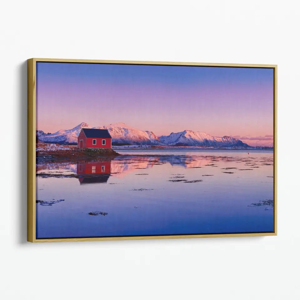 Winter lake, red rorbu house and snowy mountains